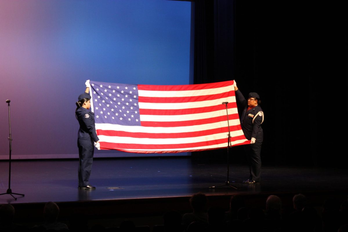 AFJROTC students present an American flag o the audience. The flag was passed to Mr. David Tigs, an MHS alumni and veteran.