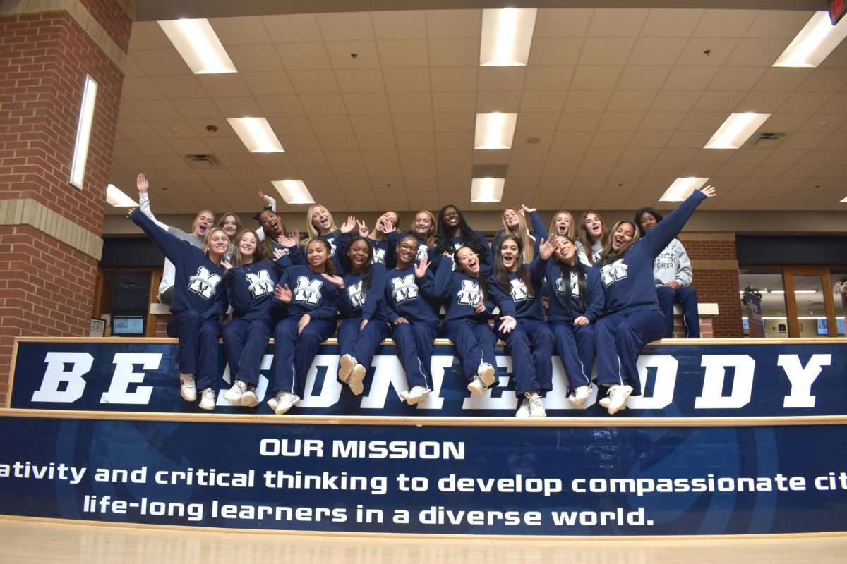 Marietta High School’s Game Day cheer team (Emma Johnson, Makayla Farris, and Ava Jane Denny not pictured) celebrates their state win while displaying Blue Devil spirit.