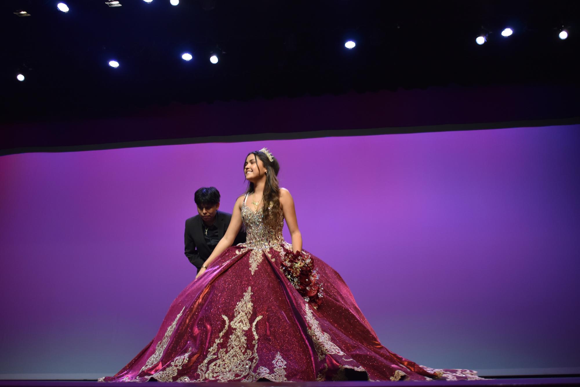 Jannet Delgadillo walks towards the front of the stage as she presents her
dress to the audience at the schoolwide HBHM celebration program.