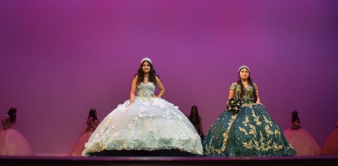 Aurelia Carbajal (left) and Astrid Roads (right) showcase thier Quinceañera
dresses in a parade of celebration.