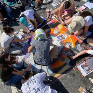 Members of the community cone together to create a drawing in Marietta Square. Photo by Morgan Odom-Harris