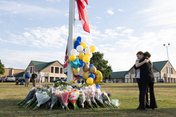 Fair Use by Getty Images
WINDER, GEORGIA - SEPTEMBER 5:  Students embrace near a makeshift memorial at Apalachee High School on September 5, 2024 in Winder, Georgia. Two students and two teachers were shot and killed at the school on September 4, and a 14-year-old suspect, who is a student at the school, is in custody.  (Photo by Jessica McGowan/Getty Images)