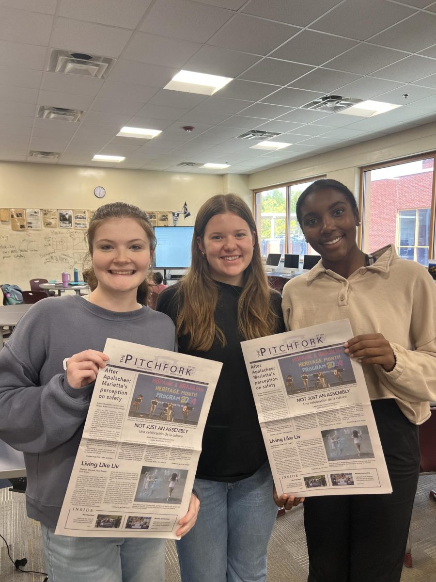 Marietta Pitchfork Editors hold up the first issue of The Pitchfork, celebrating their front page win. 