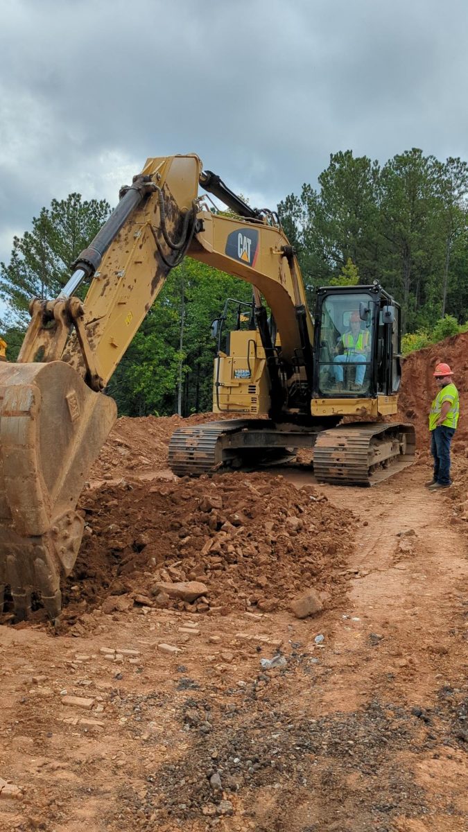 Coach Joe Street practices excavator skills on a field trip at a C. W. Matthews
project. All of the students got to give it a try as well.