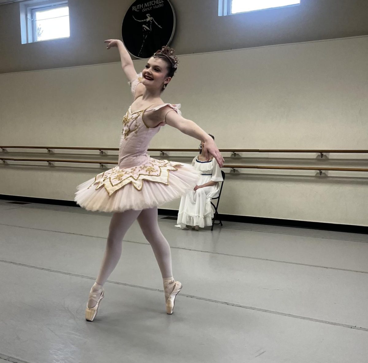 Sugar Plum Fairy, Amelia Jenkins, hits a croisé fourth en pointe at the end of her variation before her final ménage of turns. 