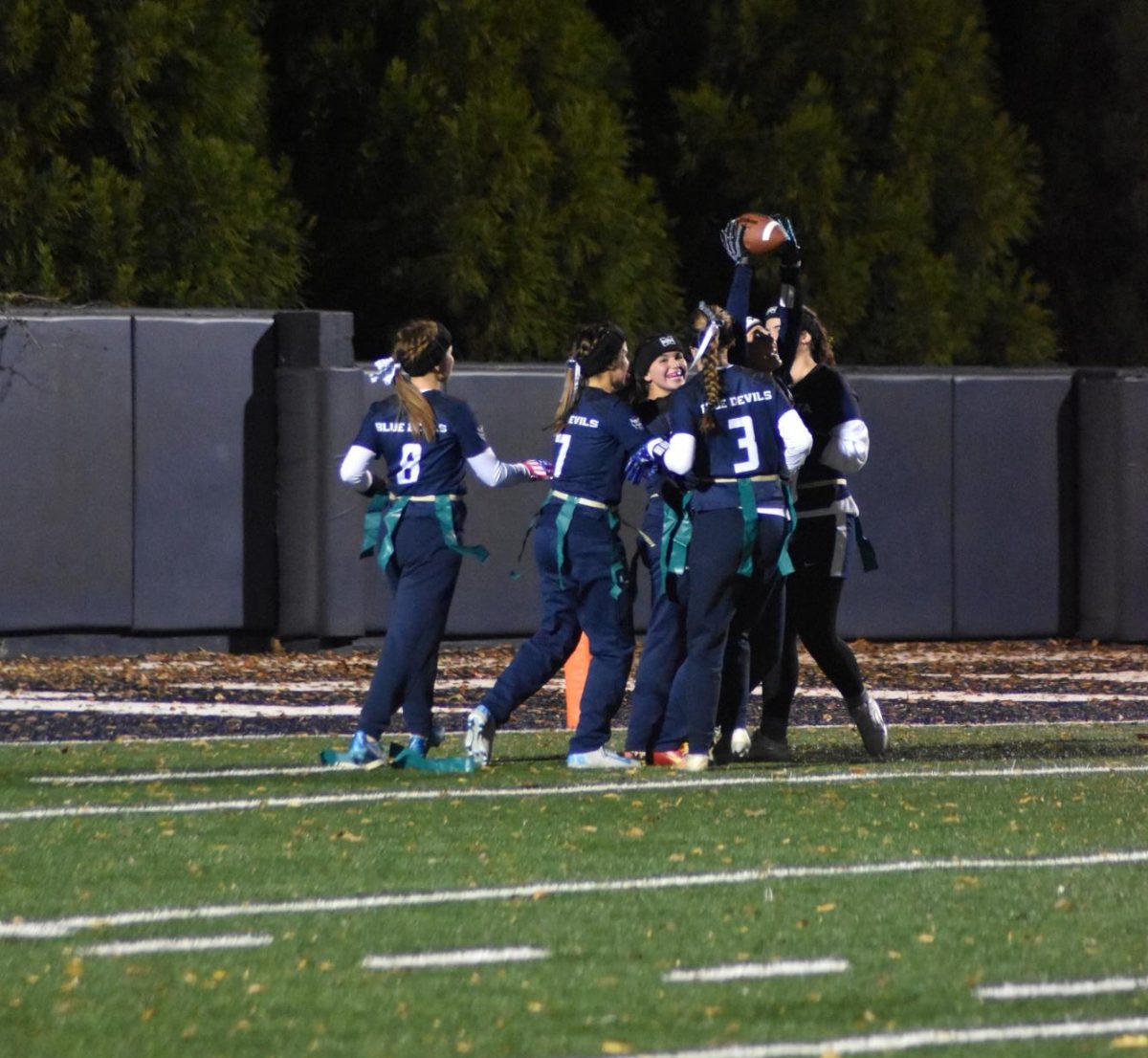 Aksana Corey (12) celebrating her touchdown with her teammates on Senior Night.