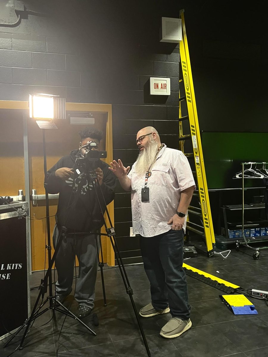 Mr. Dempsey, AVTF teacher, gives camera instruction prior to the airing of the daily news show, Good Morning Marietta.