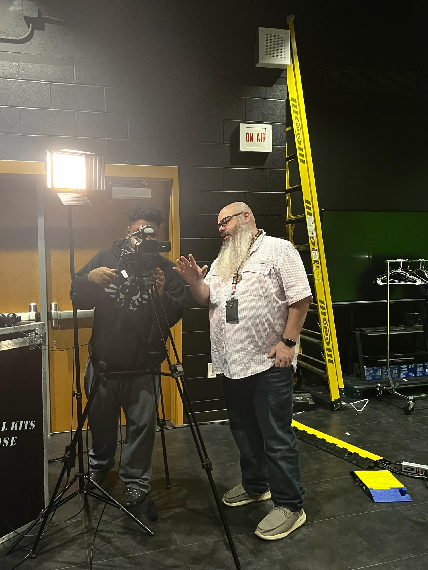 Mr. Dempsey, AVTF teacher, gives camera instruction prior to the airing of the daily news show, Good Morning Marietta.