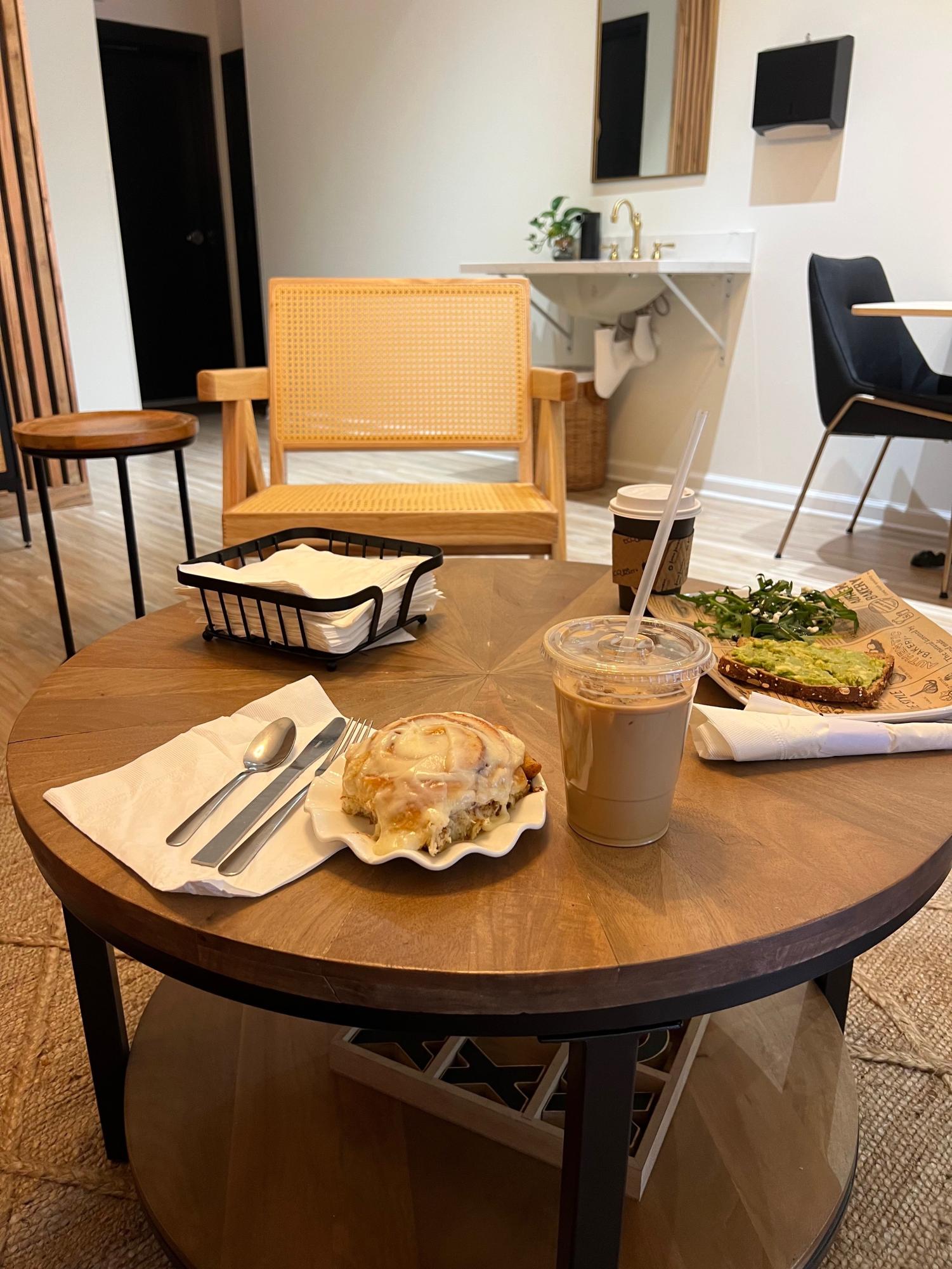 The most sold item on the menu, the cinnamon roll, along with a iced coffee. 